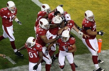 TAMPA, FL - FEBRUARY 01:  Larry Fitzgerald #11 of the Arizona Cardinals celebrates with teammates after he scored a 64-yard touchdown reception in the fourth quarter against the Pittsburgh Steelers during Super Bowl XLIII on February 1, 2009 at Raymond Ja