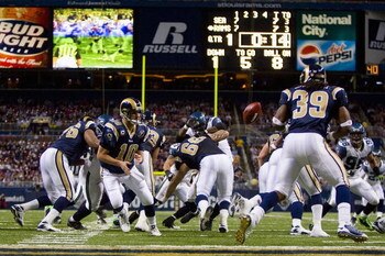 ST. LOUIS, MO - DECEMBER 14:  Marc Bulger #10 of the St. Louis Rams tosses the ball to teammate Steven Jackson #39 against the Seattle Seahawks at the Edward Jones Dome on December 14, 2008 in St. Louis, Missouri.  The Seahawks beat the Rams 23-20.  (Phot