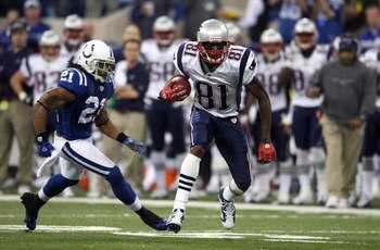 INDIANAPOLIS - NOVEMBER 04:  Randy Moss #81 of the New England Patriots runs for yards after the catch against Bob Sanders #21 of the Indianapolis Colts on November 4, 2007 at the RCA Dome in Indianapolis, Indiana.  (Photo by Andy Lyons/Getty Images)