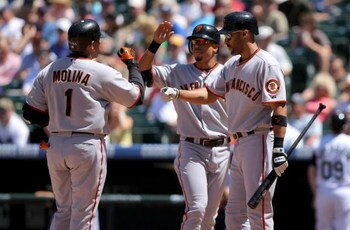 DENVER - MAY 07:  Catcher Benji Molina #1 of the San Francisco Giants is welccomed home by Emmanuel Burriss #7 and Randy Winn #2 after his two run home run off of starting pitcher Jason Marquis of the Colorado Rockies during MLB action at Coors Field on M