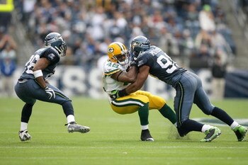 SEATTLE - OCTOBER 12:  Julian Peterson #98 of the Seattle Seahawks tackles DeShawn Wynn #42 of the Green Bay Packers during the game on October 12, 2008 at Qwest Field in Seattle, Washington. The Packers defeated the Seahawks 27-17. (Photo by Otto Greule 