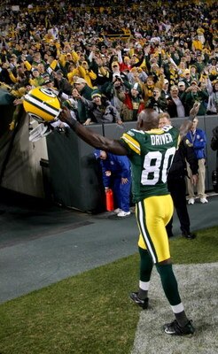 GREEN BAY, WI - OCTOBER 19:   Donald Driver #80 of the Green Bay Packers celebrates wth fans after the game with the Indianapolis Colts on October 19, 2008 at Lambeau Field in Green Bay Wisconsin. The Packers won 34-14.   (Photo by Stephen Dunn/Getty Imag