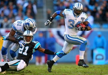 CHARLOTTE, NC - NOVEMBER 16:  Kevin Smith #34 of the Detroit Lions gets away from Ken Lucas #21 of the Carolina Panthers during their game at Bank of America Stadium on November 16, 2008 in Charlotte, North Carolina.  (Photo by Streeter Lecka/Getty Images