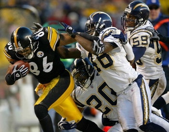 PITTSBURGH - DECEMBER 21:  Hines Ward #86 of the Pittsburgh Steelers picks up a first down as he is brought down by Terrence Keil #48, Jerry Wilson #20 and Donnie Edwards #59 of the San Diego Chargers on December 21, 2003 at Heinz Field in Pittsburgh, Pen