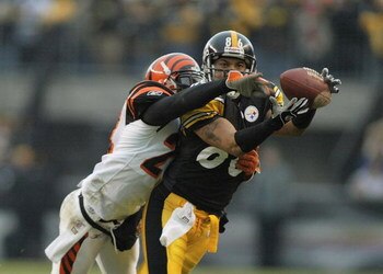 PITTSBURGH - DECEMBER 4:  Hines Ward #86 of the Pittsburgh Steelers makes a catch despite coverage by Deltha Taylor #24 of the Cincinnati Bengals December 4, 2005 at Heinz Field in Pittsburgh, Pennsylvania.  (Photo by Rick Stewart/Getty Images)