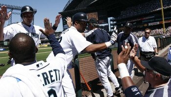 SEATTLE - JULY 23:   Eduardo Perez #33 (C) and Raul Ibanez #28  (upper L) of the Seattle Mariners are congratulated by Carl Everett #8 and Manager Mike Hargrove (bottom R) after Perez hit a two run homer in the third inning against the Boston Red Sox on J