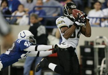 INDIANAPOLIS - OCTOBER 24:  Wide receiver Jimmy Smith #82 of the Jacksonville Jaguars evades defensive back Jason David #42 of the Indianapolis Colts during the game on October 24, 2004 at the RCA Dome in Indianapolis, Indiana. The Jaguars defeated the Co