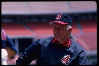 1986:  All time great Atlanta Braves pitcher Phil Niekro, now a coach of the Cleveland Indians, talks with Reggie Jackson.   Mandatory Credit:  Steve Dunn/Allsport