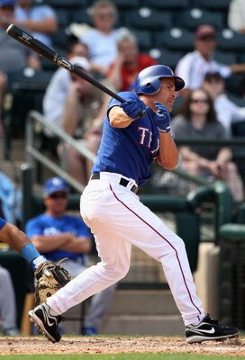 SURPRISE, AZ - MARCH 04:  Omar Vizquel #13 of the Texas Rangers bats against the Kansas City Royals during the spring training game at Surprise Stadium on March 4, 2009 in Surprise, Arizona. The Rangers defeated the Royals 5-3.  (Photo by Christian Peters