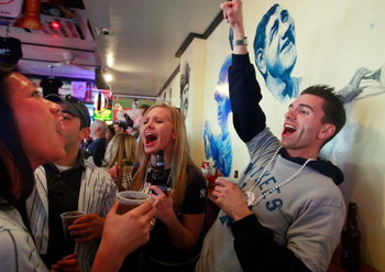 NEW YORK - APRIL 16: Yankees fans celebrate in the famous Stan's bar near the new Yankee Stadium before the first pitch on opening day April 16, 2009 in the Bronx borough of New York City. The New York Yankees are playing against the Cleveland Indians in