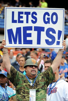 NEW YORK - SEPTEMBER 28: Fans hold a signs before the start of the last regular season baseball game ever played in Shea Stadium featuring the New York Mets and the Florida Marlins on September 28, 2008 in the Flushing neighborhood of the Queens borough