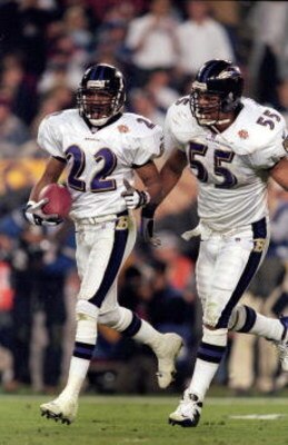 28 Jan 2001:  Duane Starks #22 of the Baltimore Ravens celebrates with teammate Jamie Sharper #55 after an interception touchdown during the Super Bowl XXXV Game against the New York Giants at the Raymond James Stadium in Tampa, Florida. The Ravens defeat