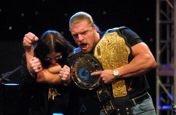 Ozzy Osbourne with WWF wrestler Triple H during a press conference to announce the Ozzfest 2002 line-up and partnership with the WWF at the WWF/World Theater in Times Square in New York City.  3/21/02  Photo by Scott Gries/ImageDirect