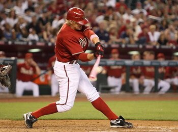 PHOENIX - MAY 10:  Eric Byrnes #22 of the Arizona Diamondbacks hits a RBI double against the Washington Nationals during the third inning of the major league baseball game at Chase Field on May 10, 2009 in Phoenix, Arizona.  (Photo by Christian Petersen/G