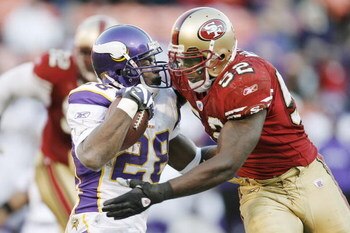 SAN FRANCISCO - DECEMBER 9:  Running back Adrian Peterson #28 of the Minnesota Vikings is hit by linerbacker Patrick Willis #52 of the San Francisco 49ers during a game on December 9, 2007 at Monster Park in San Francisco, California. Minnesota won 27-7. 