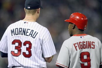 MINNEAPOLIS - MARCH 31: First basemanJustin Morneau #33 of the Minnesota Twins stands with Chone Figgins #9 the Los Angeles Angels of Anaheim during the Opening Day game on March 31, 2008 at the Hubert H. Humphrey Metrodome in Minneapolis, Minnesota. (Pho