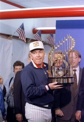 Manager Tom Kelly of the Minnesota Twins celebrates with the trophy after game seven of the World Series against the Atlanta Braves.