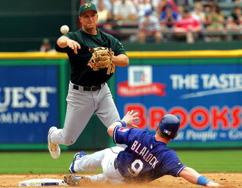 ARLINGTON, TX - APRIL 19: Second baseman Mark Ellis #14 of the Oakland Athletics makes the out against Hank Blalock #9 of the Texas Rangers on April 19, 2005 at Ameriquest Field in Arlington in Arlington, Texas. (Photo by Ronald Martinez/Getty Images)