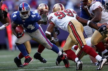 EAST RUTHERFORD, NJ - OCTOBER 19:  Ahmad Bradshaw #44 of the New York Giants pushes off a tackle from Manny Lawson #99 of the San Francisco 49ers on October 19, 2008 at Giant Stadium in East Rutherford, New Jersey. The Giants defeated the 49ers 27-19. (Ph