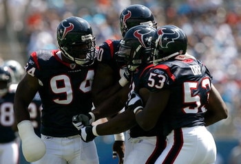 CHARLOTTE, NC - SEPTEMBER 16:  Defenders N. D. Kalu #94, Mario Williams #90 and Shantee Orr #53 of the Houston Texans celebrate with Amobi Okoye #91 after Okoye recorded a sack against the Carolina Panthers during the first half at Bank of America Stadium