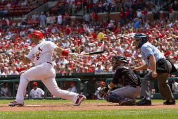ST. LOUIS, MO - APRIL 23: Albert Pujols #5 of the St. Louis Cardinals hits an RBI single against the New York Mets on April 23, 2009 at Busch Stadium in St. Louis, Missouri. The Cardinals beat the Mets 12-8.  (Photo by Dilip Vishwanat/Getty Images)