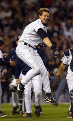 BRONX, NY - OCTOBER 16:  Aaron Boone #19 of the New York Yankees celebrates after hitting the game winning home run in the bottom of the eleventh inning against the Boston Red Sox during game 7 of the American League Championship Series on October 16, 200