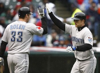 CLEVELAND - APRIL 10:  Adam Lind #26 (R) of the Toronto Blue Jays celebrates with Scott Rolen #33 after scoring against the Cleveland Indians in the fourth inning April 10, 2009 at Progressive Field in Cleveland, Ohio.  (Photo by Matt Sullivan/Getty Image
