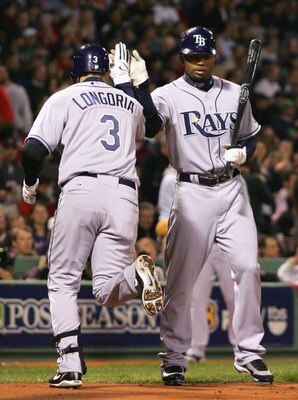 BOSTON - OCTOBER 14:   Evan Longoria #3 of the Tampa Bay Rays is congratulated by teammate Carl Crawford#13 after Longoria hit a solo home run against the Boston Red Sox in game four of the American League Championship Series during the 2008 MLB playoffs 