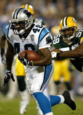 CHARLOTTE, NC - SEPTEMBER 13:  Steven Davis #48 of the Carolina Panthers runs the ball past Mike Flanagan #58 of the Green Bay Packers September 13, 2004 at Bank of America Stadium in Charlotte, North Carolina. (Photo by Streeter Lecka/Getty Images)