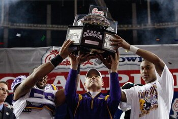 ATLANTA - DECEMBER 31: Linebacker Perry Riley #56, head coach Les Miles and quarterback Jordan Jefferson #9 of the LSU Tigers lift up the trophy after a 38-3 win over the Georgia Tech Yellow Jackets in the Chick-fil-A Bowl on December 31, 2008 at the Geor