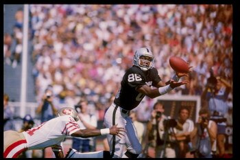 22 Sep 1985: Wide receiver Jim Smith of the Los Angeles Raiders reaches to catch the ball during a game against the San Francisco 49ers at the Los Angeles Memorial Coliseum in Los Angeles, California. The 49ers won the game 34-10.
