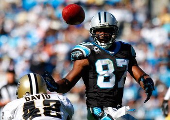 CHARLOTTE, NC - OCTOBER 19:  Jason David #42 of the New Orleans Saints watches as receiver Muhsin Muhammad #87 of the Carolina Panthers tips this pass into his own hands for a reception during the game at Bank of America Stadium on October 19, 2008 in Cha