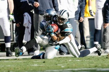 CHARLOTTE, NC - DECEMBER 16:  Steve Smith #89 of the Carolina Panthers catches the ball under pressure against the Seattle Seahawks during the second half at Bank of America Stadium on December 16, 2007 in Charlotte, North Carolina.  Carolina defeated Sea