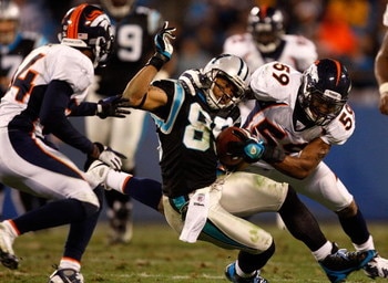 CHARLOTTE, NC - DECEMBER 14:  Wesley Woodyard #59 of the Denver Broncos tackles Steve Smith #89 of the Carolina Panthers during their game at Bank of America Stadium on December 14, 2008 in Charlotte, North Carolina  (Photo by Streeter Lecka/Getty Images)