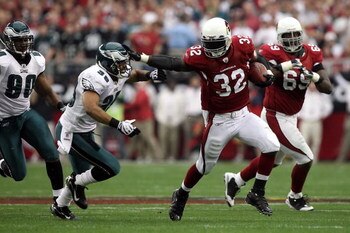 GLENDALE, AZ - JANUARY 18:  Running back Edgerrin James #32 of the Arizona Cardinals uses a stiff arm to get by Quintin Demps #39 of the Philadelphia Eagles in the first quarter during the NFC championship game on January 18, 2009 at University of Phoenix