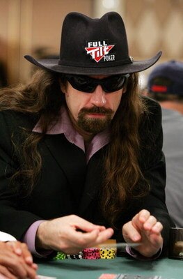 LAS VEGAS - JULY 29:  Poker player Chris 'Jesus' Ferguson folds as he competes on the second day of the first round of the World Series of Poker no-limit Texas Hold 'em main event at the Rio Hotel & Casino July 29, 2006 in Las Vegas, Nevada. More than 8,6
