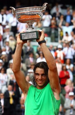 PARIS - JUNE 08:  Rafael Nadal of Spain lifts the trophy after defeating Roger Federer of Switzerland after the Men's Singles Final match on day fifteen of the French Open at Roland Garros on June 8, 2008 in Paris, France.  (Photo by Julian Finney/Getty I