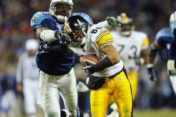 NASHVILLE, TN - JANUARY 11: Hines Ward #86 of the Pittsburgh Steelers tries to evade the grasp of Keith Bulluck #53 of the Tennessee Titans during the AFC divisional playoff game at the Coliseum on January 11, 2003 in Nashville, Tennessee. The Titans w
