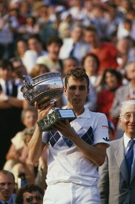 Czech tennis player Ivan Lendl with the trophy after winning the men's singles final of the Tournoi de Roland-Garros (French Open), at the Stade Roland Garros, Paris, June 1984. Lendl beat John McEnroe of the USA to win the match 3-6, 2-6, 6-4, 7-5, 7-5.
