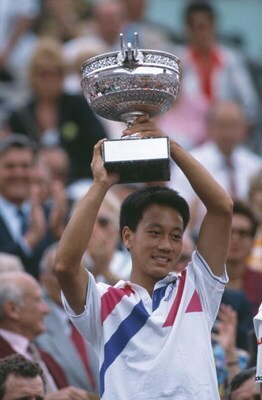 American tennis player Michael Chang at the French Open in Paris, 1989. He won the tournament, becoming the youngest male winner of a Grand Slam singles event at the age of 17. (Photo by Bob Martin/Getty Images)