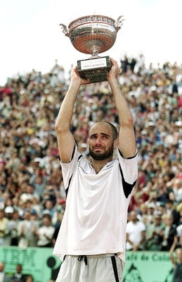 6 Jun 1999:  Andre Agassi of the USA lifts the trophy high above his head after defeating Andrei Medvedev of the Ukraine to win the men's singles final of the French Open at Roland Garros in Paris, France. Mandatory Credit: Al Bello  /Allsport