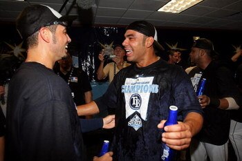 ST PETERSBURG, FL - OCTOBER 19:  Carlos Pena #23 and Jason Bartlett (L) #8 of the Tampa Bay Rays celebrates after defeating the Boston Red Sox in game seven of the American League Championship Series during the 2008 MLB playoffs on October 19, 2008 at Tro
