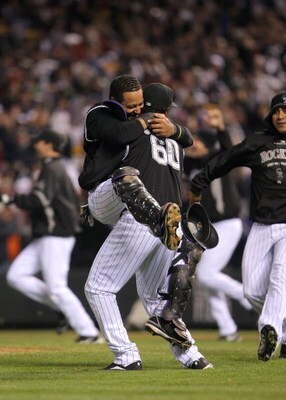 DENVER - OCTOBER 15:  Manny Corpas #60 and Yorvit Torrealba #8 of the Colorado Rockies celebrate their 6-4 win to advance to the World Series over the Arizona Diamondbacks during Game Four of the National League Championship Series at Coors Field on Octob