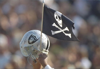 9 Jan 1994:  A Los Angeles Raiders fan waves a helmet and flag during a playoff game against the Denver Broncos at the Los Angeles Memorial Coliseum in Los Angeles, California.  The Raiders won the game, 42-24. Mandatory Credit: Al Bello  /Allsport