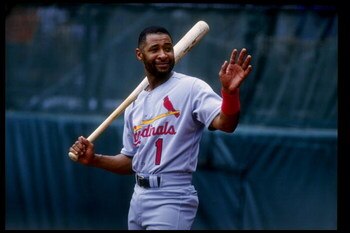 25 Jul 1993: Shortstop Ozzie Smith of the St. Louis Cardinals carries a bat over his shoulder and waves during a game against the Colorado Rockies at Coors Field in Denver, Colorado.