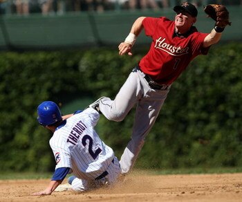 CHICAGO - SEPTEMBER 2:  Ryan Theriot #2 of the Chicago Cubs steals second base in the 3rd inning as Craig Biggio #7 of the Houston Astros leaps to try and catch an errant throw at Wrigley Field September 2, 2007 in Chicago, Illinois.  (Photo by Jonathan D