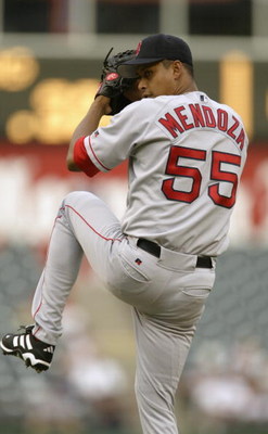 ARLINGTON, TEXAS - JULY 30:  Pitcher Ramiro Mendoza #55 of the Boston Red Sox winds up for the pitch during the American League game against the Texas Rangers at the Ballpark in Arlington on July 30, 2003 in Arlington, Texas.  The Rangers defeated the Red