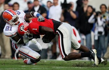 JACKSONVILLE, FL - NOVEMBER 01:  Split end Mohamed Massaquoi #1 of the Georgia Bulldogs hauls in a reception as he is brought down by safety Major Wright #21 of the Florida Gators at Jacksonville Municipal Stadium on November 1, 2008 in Jacksonville, Flor