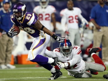 MINNEAPOLIS - DECEMBER 28:   Chester Taylor #29 of the Minnesota Vikings carries the ball for a first down as James Butler #37 of the New York Giants defends on December 28, 2008 at the Hubert H. Humphrey Metrodome in Minneapolis, Minnesota. The Vikings d