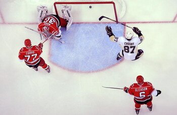 RALEIGH, NC - MAY 23:  Sidney Crosby #87 of the Pittsburgh Penguins scores a goal past goaltender Cam Ward #30, Joe Corvo #77 and Tim Gleason #6 of the Carolina Hurricanes during Game Three of the Eastern Conference Championship Round of the 2009 Stanley 